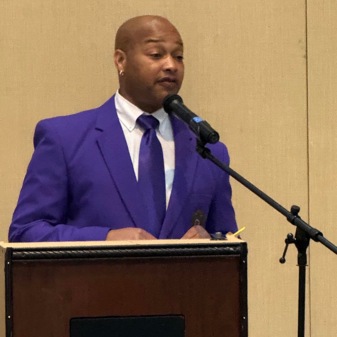Chapter member speaking at a podium